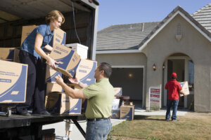 People moving boxes out of truck